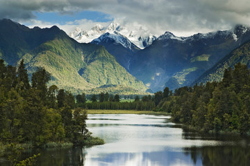 New Zealand, South Island. Cloud-shrouded Mt. Cook as seen from Lake Matheson near the town of Fox Glacier. 