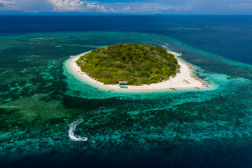 Aerial drone view of a beautiful tropical island and surrounding coral reef