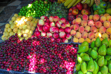 Summer fruits in bazaar,cherries,apricots,peaches,figs,nectarine,red apples,green apples