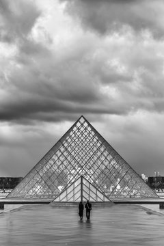 iew of famous Louvre Museum with Louvre Pyramid at evening