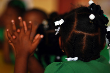 Dominica, Roseau, Preschool Social Center, rear portrait of girl with braids