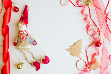 Christmas gift box with red ribbon and spruce branch on the white background over pine cones,isolated,top view,flat lay,space for text