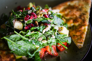 Fototapeta na wymiar fresh quinoa salad with mix of vegetables & focaccia bread