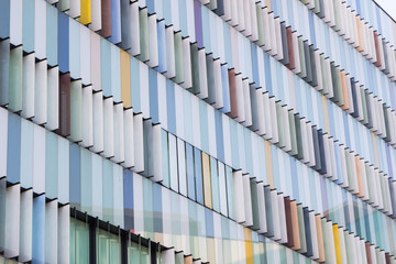 MILAN ITALY OCTOBER 13, 2017 Modern exterior of a bright & colorful office building in Milan, Italy in blue sky background, Beautiful & colorful window building.