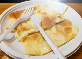 Soft focus. White pizza, Focaccia formaggio italian cheese flatbread,  focaccia di recco traditional italian liguria , genova region in white plate on the wood table in restaurant.