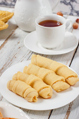 Traditional Azerbaijan holiday Novruz cookies baklava on white plate on the white background with nuts and shakarbura,gogal,sweetbread,tea,lemon,kata,mutaki,flat lay,top view,space for copy