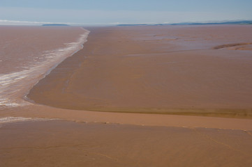 Fototapeta na wymiar Canada, New Brunswick, Hopewell Cape, Bay of Fundy. Daniel Flats, views of mud flats at mid-tide.