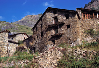 Fototapeta na wymiar Andorra. Crumbling stone walls dot the hillsides in Andorra.