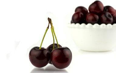 close-up some cherries with stems. Isolated on white background.