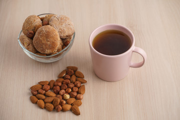 cup of tea with cookies and nuts