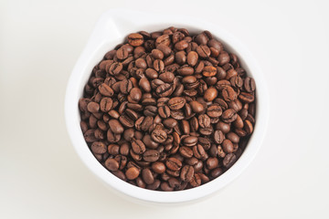 Fototapeta na wymiar coffee beans in a white cup