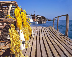 Canada, Nova Scotia, Martime Drive. Yellow ropes and lobster traps wait on a wooden pier in Nova Scotia, Canada.