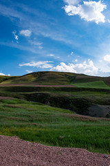 Turkey, aerial view of the breathtaking landscape on the dirt and winding road on the plateau around Mount Ararat, Agri Dagi, with rocky peaks, hills, grassland and flowers near the Ishak Pasha Palace