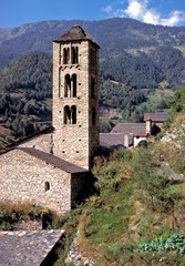 Fototapeta na wymiar Andorra, Sant Climent de Pal. A stone clock tower indicates the center of a small village.