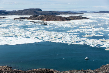Canada, Nunavut Territory, C-Dory expedition boat surrounded by melting sea ice in Hudson Bay near Arctic Circle in Frozen Channel by White Island © Paul Souders/Danita Delimont