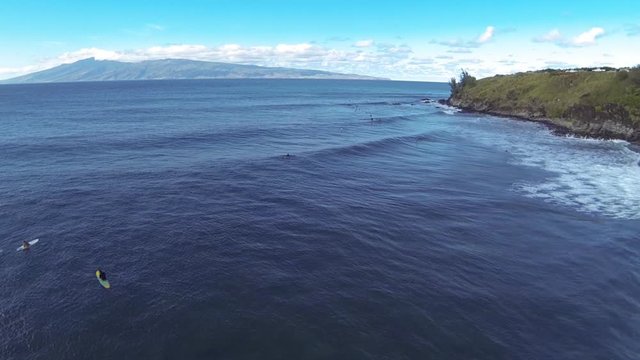 Aerial shot of sufers in Hawaii 
