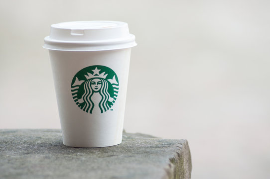 Closeup of white take away cup in outdoor from Starbuck brand, Starbuck is the famous chain of fast food