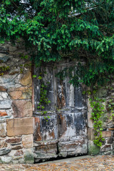 Fototapeta na wymiar France, Najac. Wooden door in stone wall