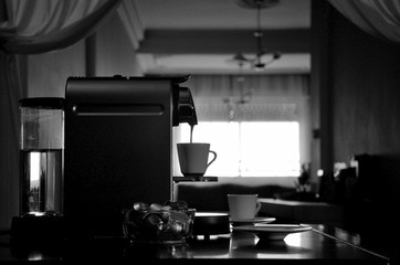 Espresso coffee machine in silhouette, view of sets when filling coffee cup.
