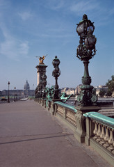 Fototapeta na wymiar France, Paris. Art Nouveau lamp posts line Pont Alexandre III, part of a World Heritage Site, leading to the Dome Church and Invalides in Paris, France.