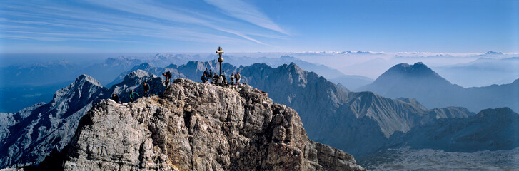 Germany, Bavaria, Zugspitze. Hikers enjoy an inspiring view to the Tirol from the Zugspitze summit in Bavaria, Germany. - obrazy, fototapety, plakaty