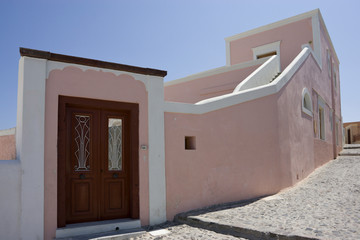 Greece, Santorini, Thira, Oia. Pink villa with wooden door.