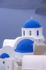 Fototapeta na wymiar Greece, Santorini, Oia. Blue domed church overlooking the Sea of Crete