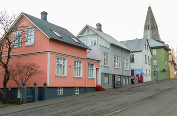 Iceland, Reykjavik. Church steeple and house-lined street.