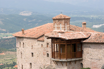 Greece, Meteora. Overview of Saint Barbara Roussanou Monastery and wood balcony.