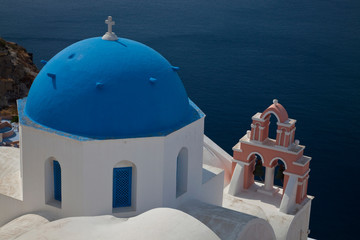 Greece, Santorini. Bell tower and blue domes of church in village of Oia