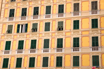 Fototapeta na wymiar Italy, Camogli. Building painted in the trompe d'oeil or fool-the-eye style of decoration so that some windows are painted.