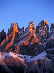 Italy, Odle Group. Red sunset light washes the craggy peaks of the Odle Group, in the Dolomite...