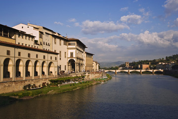Italy, Tuscany, Florence. Daytime view of the Ponte Vecchio bridge, built in 1345, spanning the Arno River. 