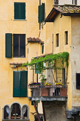 Fototapeta na wymiar Italy, Tuscany, Florence. Balcony and buildings near the Ponte Vecchio bridge. 