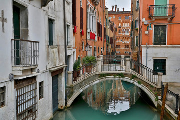 Fototapeta na wymiar Canal and Bridges with boats Venice Italy