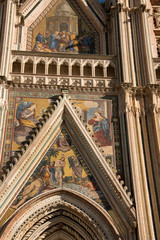 Italy, Umbria, Orvieto. The Cathedral of Orvieto or Duomo of Orvieto. 13th century Gothic masterpiece, one of the best Gothic buildings in Italy. Detail of facade with religious mosaic..