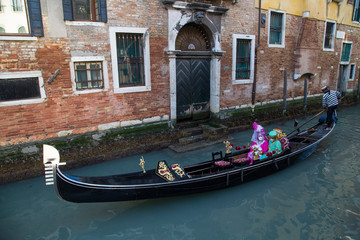 Fototapeta na wymiar Couple dressed for Gondola ride Venice at Carnival Time, Italy