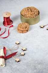 Handmade gift. Composition of cookies, decor, red ribbon, congratulations letters. Light background. The vertical orientation of the frame. Free space for text.