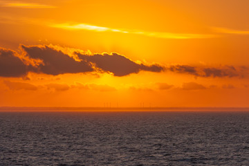 Wind turbines on the Italian coast during a beautiful sunset