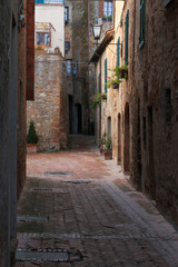 Italy, Val d'Orcia in Tuscany, Siena, Pienza, a hill town. UNESCO World Heritage Site. Narrow street.