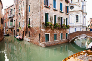 Fototapeta na wymiar Venice, Veneto, Italy - Buildings are surrounded by the canals in Venice, Italy. Boats can be seen in the canals.