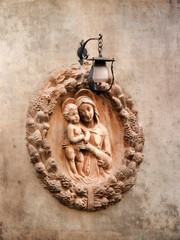 Italy, Tuscany. Terra cotta adornment on a wall in the town of Impruneta.