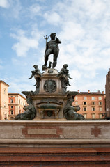 Fototapeta na wymiar Bologna, Emilia-Romagna, Italy - Stone steps leading to a fountain with a statue of the Roman god Neptune.