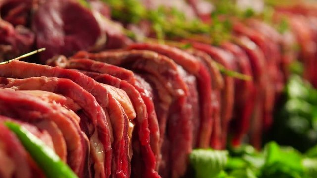 Selective focus, rows of raw red meat for a party. Rack focus.