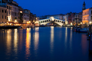 Fototapeta na wymiar Grand Canal with View of Rialto Bridge with Evening Blue light and Lights.