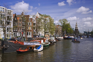Fototapeta na wymiar Netherlands, Amsterdam. Boats on a busy canal. 