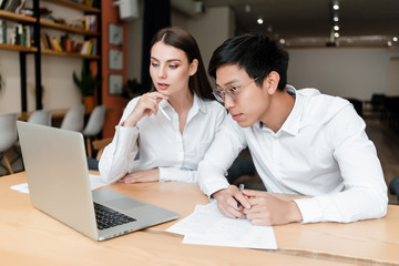 multiracial team of man and woman working in the office