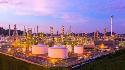 Fototapeta na wymiar Oil​ refinery​ with oil storage tank and petrochemical​ plant industrial background at twilight, Aerial view oil and gas refinery at twilight.