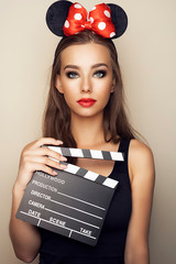 portrait of young woman with clapperboard