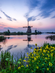 Fototapeta premium Netherlands, Kinderdijk, Windmills at Sunrise along the canals of Kinderdijk